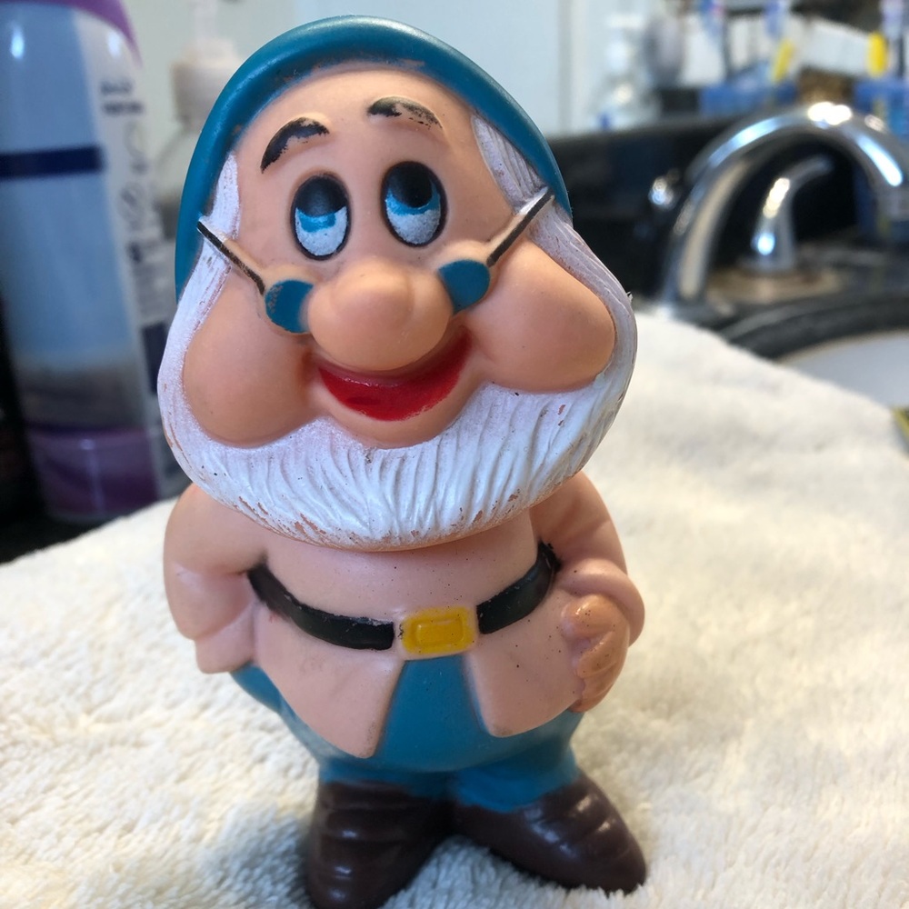 Vintage rubber squeaker toy figurine of Doc, the leader of the Seven Dwarfs